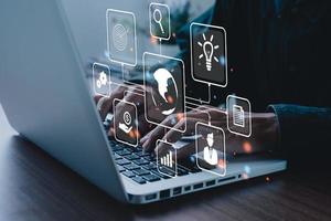 Businessman using on laptop computer in office with virtual interface icons network diagram and digital marketing, Financial and banking, Digital link tech, big data. photo