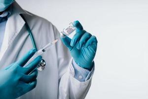 Omicron variant of SARS-CoV-2. New B.1.1.529 Variant of concern. Doctor holds vaccine against new covid-19 omicron variant. New generation vaccine against. photo
