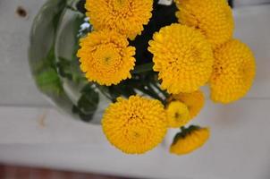 Yellow bouquet in a glass vase photo