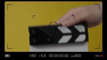 Movie slate or clapperboard hitting. Close up hand holding empty film slate and clapping it.