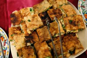 Thick folded crepe filled with spices and pieces of meat photo