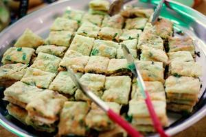 Thick folded crepe filled with spices and pieces of meat photo