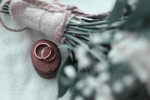 A pair of wedding rings on a wood photo