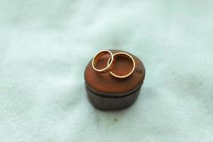 A pair of wedding rings on a wood photo