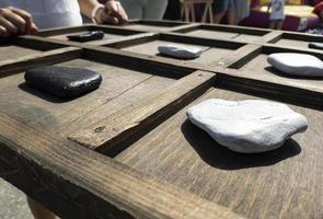 tic-tac-toe game made with wood and stones photo