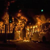 protesters set fire to public transport buses in the city of Rio de Janeiro, Brazil.