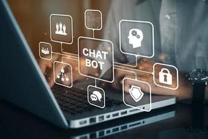 Person working on computer with icons of Chatbot computer program designed for conversation with human users over the Internet. Support and customer service automation technology concept. photo