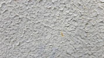 Gray metal wall background. Light peeling texture. Dirty rusty metal wall. Retro effect Cracks, grunge, rough stucco. Old gray metal door. Old gray cracked paint on a metal door. photo