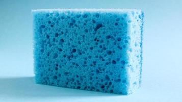 One blue sponge used to wash and erase dirt used by housewives in everyday life. They are made of porous material such as foam. Detergent retention, which allows you to spend it economically photo