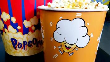 Ukraine, Kiev - September 10, 2019. two large and medium paper bucket with popcorn with copy space, concept for watching TV or a movie photo