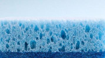 One blue sponge used to wash and erase dirt used by housewives in everyday life. They are made of porous material such as foam. Detergent retention, which allows you to spend it economically photo