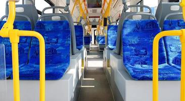 Ukraine, Kiev - September 08, 2019. Empty city tram salon. Public ground transportation within the city. Seats for passengers. Handrails for carrying out. Contactless payments of transport validators. photo