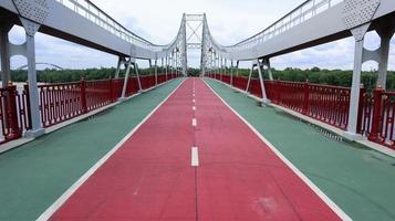 Park pedestrian bridge over the Dnieper River, which connects the central part of Kiev with the park area and the beaches of Trukhanovy Island. Without people. photo