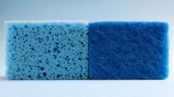 Two blue sponges used for washing and erasing dirt used by housewives in everyday life. They are made of porous material such as foam. Detergent retention, which allows you to spend it economically photo