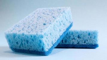 Two blue sponges used for washing and erasing dirt used by housewives in everyday life. They are made of porous material such as foam. Detergent retention, which allows you to spend it economically photo