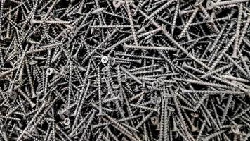 steel screws, metal screw, iron screw, screws as a background, wood screw. Iron or metal screw nails stack industrial building industry background. photo