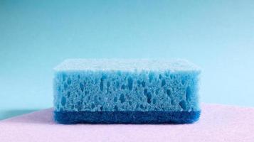 One blue sponge used to wash and erase dirt used by housewives in everyday life. They are made of porous material such as foam. Detergent retention, which allows you to spend it economically photo