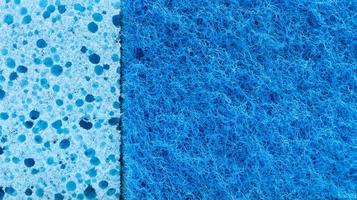 Background in the form of a porous structure in blue. Macro sponge. Close up blue sponge surface for textured background. copy space. photo