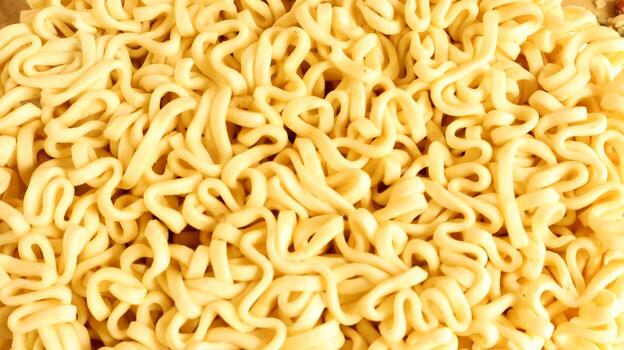 Close Up texture of instant noodles. pasta, for the preparation of which it is enough to pour boiling water and wait a few minutes. Fragrances are also commonly added to add flavor. photo