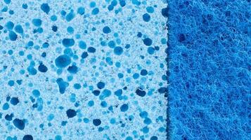 Background in the form of a porous structure in blue. Macro sponge. Close up blue sponge surface for textured background. copy space. photo