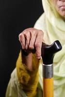 senior women hands on walking stick, photo