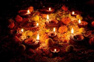 Clay diya lamps lit during Diwali Celebration. Greetings Card Design Indian Hindu Light Festival called Diwali photo