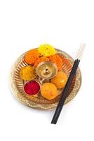 Beautifully Decorated Pooja Thali for festival celebration to worship, haldi or turmeric powder and kumkum, flowers, scented sticks in brass plate, hindu puja thali photo