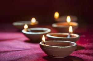 Clay diya lamps lit during Diwali Celebration. Greetings Card Design Indian Hindu Light Festival called Diwali photo