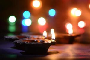 Clay diya lamps lit during Diwali Celebration. Greetings Card Design Indian Hindu Light Festival called Diwali photo