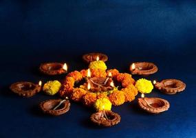 Clay diya lamps lit during diwali celebration. Greetings Card Design Indian Hindu Light Festival called Diwali photo