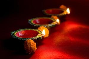 Happy Diwali - Clay Diya lamps lit during Diwali celebration. Greetings Card Design of Indian Hindu Light Festival called Diwali photo