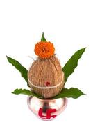 Copper Kalash with coconut and mango leaf with floral decoration on a white background. Essential in Hindu Puja. photo