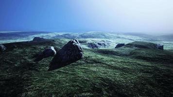 big sand stone and green grass hill background video