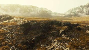 Beautiful scenic sunset view at mountain range and dry yellow grass in front video