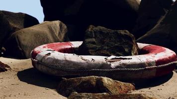 old life buoy on sandy beach video