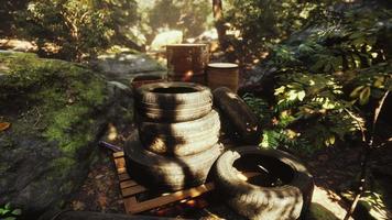 old used wheels in the tropical forest as pollution concept video