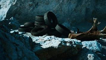 old tires overgrown embedded in the sand video