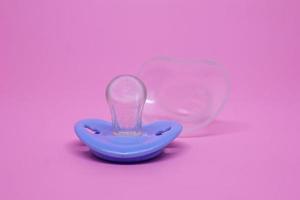 Baby pacifier isolated on pink background photo