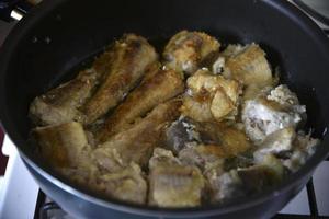 Fried fish until golden brown in a frying pan photo