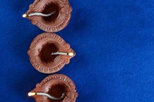 Clay diya lamps lit during diwali celebration. Greetings Card Design Indian Hindu Light Festival called Diwali photo