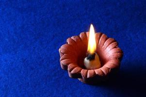 Clay diya lamps lit during diwali celebration. Greetings Card Design Indian Hindu Light Festival called Diwali photo