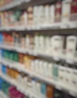 Blurred passage of a supermarket with shelves with goods. abstract passage in the supermarket with colorful goods on the shelves, can be used as a background or for your other project photo