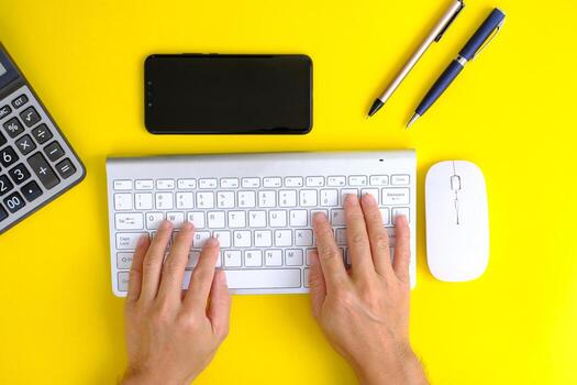 Notebook with pen are on top of office desk table with computer tools and supplies. Top view with copy space, flat lay.  Finance and banking advertising photo