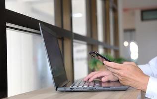 Businessman utilizing mobile smartphone and network connection photo