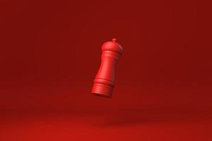 Red Pepper mill floating in Red background. minimal concept idea creative. monochrome. 3D render. photo