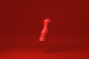 Red Pepper mill floating in Red background. minimal concept idea creative. monochrome. 3D render. photo