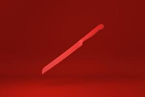 Red Kitchen knife floating in Red background. minimal concept idea creative. monochrome. 3D render. photo