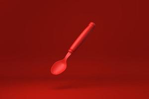 Red spoon floating in Red background. minimal concept idea creative. monochrome. 3D render. photo