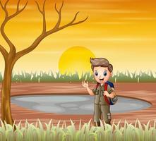 The scout boy standing under a dry tree vector