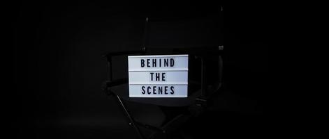 Director chair with behind the scene banner light box. photo